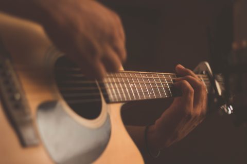 Photo of a guitar being played